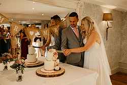 Bride and Groom cutting cake in the Hampshire suite at Old Thorns Hotel & Resort Hampshire